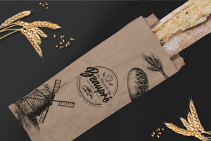 Sachet craft pour baguette de pain imprimée et personnalisée avec le logo de la boulangerie et des illustrations.
